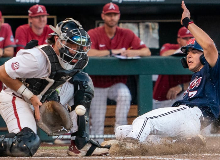 Razorbacks catcher Michael Turner takes a late throw at home in the 12-3 loss to Ole Miss on Monday evening at the College World Series in Omaha, Nebraska.